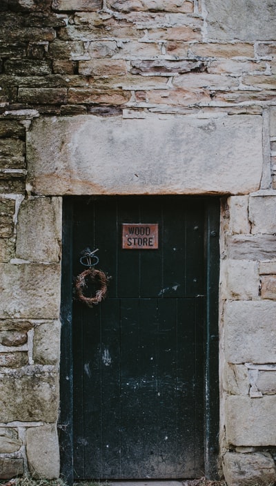 Black wooden door, wooden shop sign
